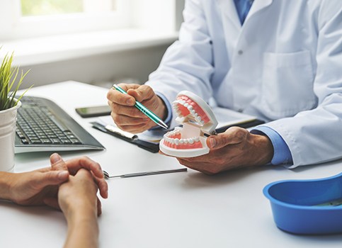 A patient consulting their dentist in an office setting
