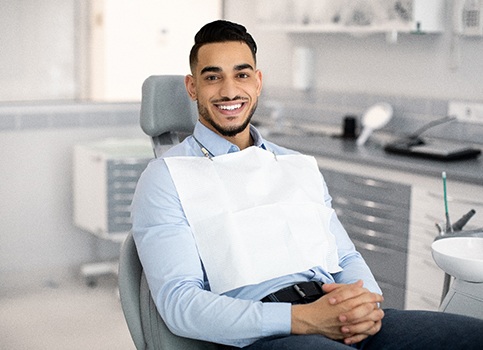 Patient smiling while sitting in treatment chair
