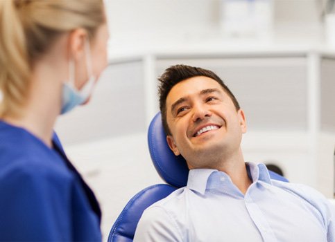 man talking with dentist for teeth whitening in Sunnyside